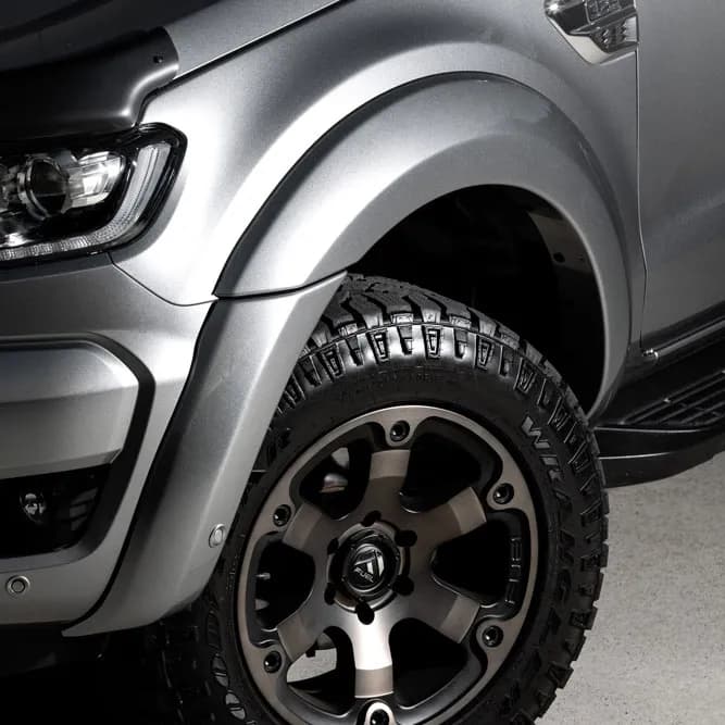 Close-up of EGR fender flares on a silver ute's front wheel arch